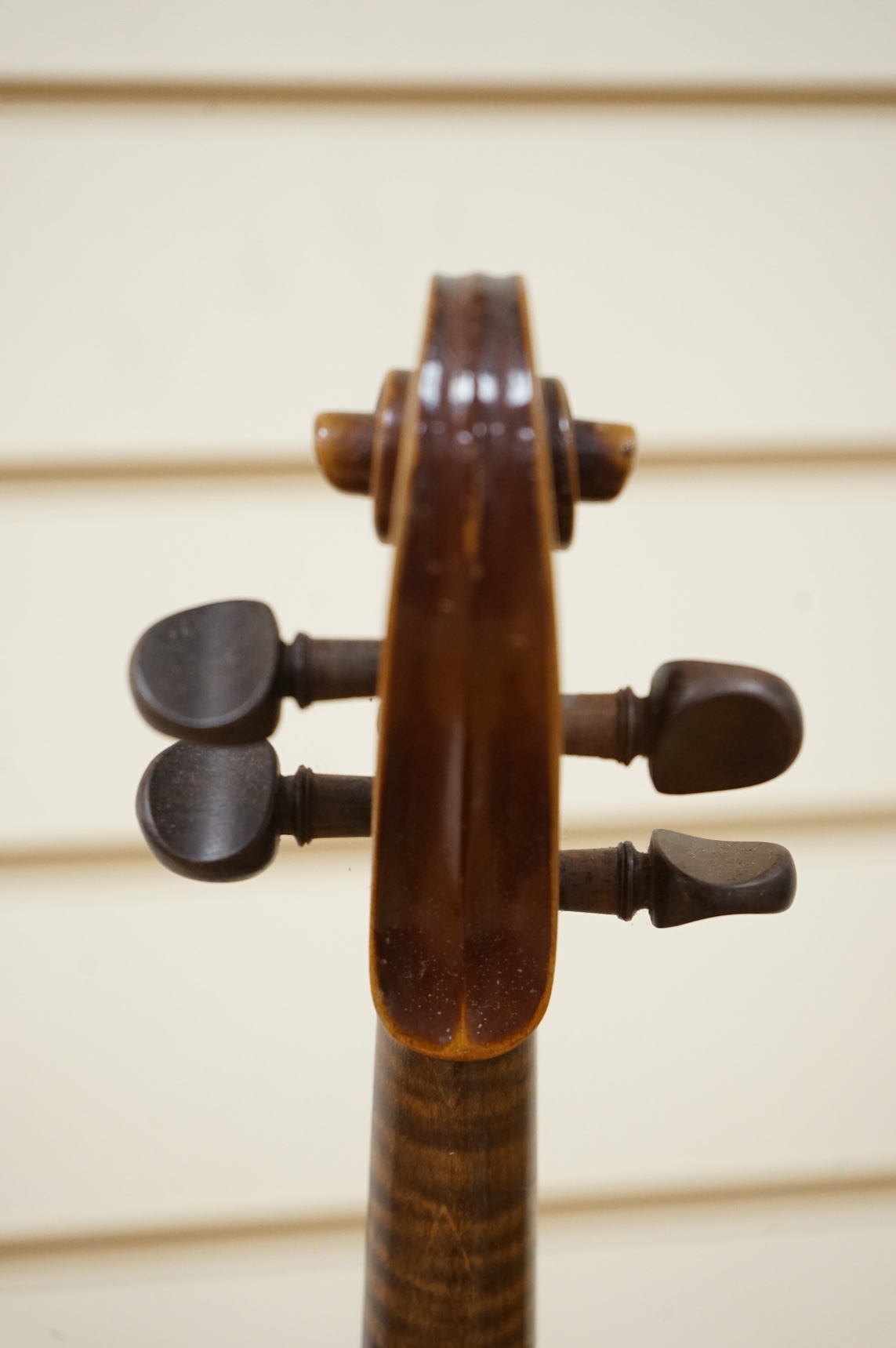 Five cased 20th century violins, including; a German violin, two Czech violins, a three-quarter size violin with a label for Bienfait, and a Romanian quarter size violin, all in cases or the remains of cases.